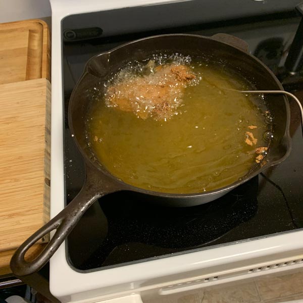 Breaded Chicken Thigh Added to Hot Frying Oil