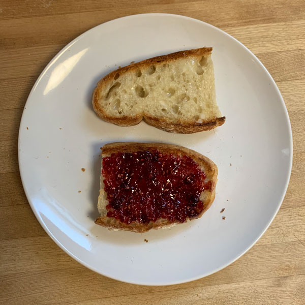 Homemade French Bread with Butter and Raspberry Preserves